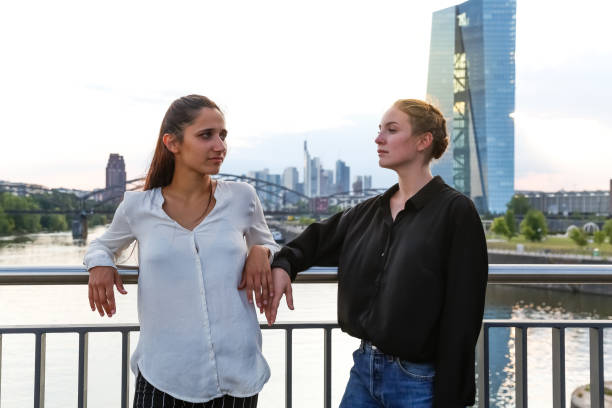 istock Young Women Posing on City Bridge Over River 1038879830