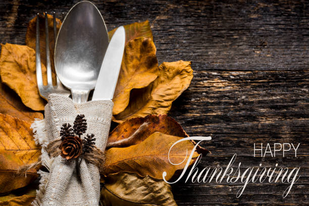 istock Thanksgiving Meal Setting. Seasonal table setting. Thanksgiving autumn place setting with cutlery and arrangement of colorful fall leaves. 1038884144