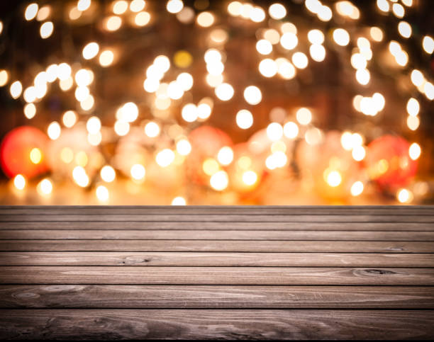 istock Empty rustic wooden table with blurred Christmas lights at background 1038897748