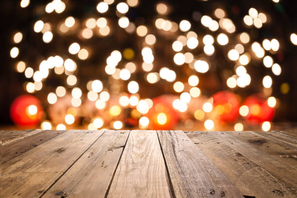 istock Empty rustic wooden table with blurred Christmas lights at background 1038897826