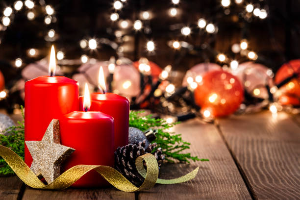 istock Christmas candles on rustic wooden table 1038898244
