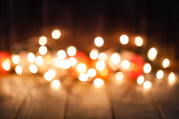 istock Empty rustic wooden table with blurred Christmas lights at background 1038898428
