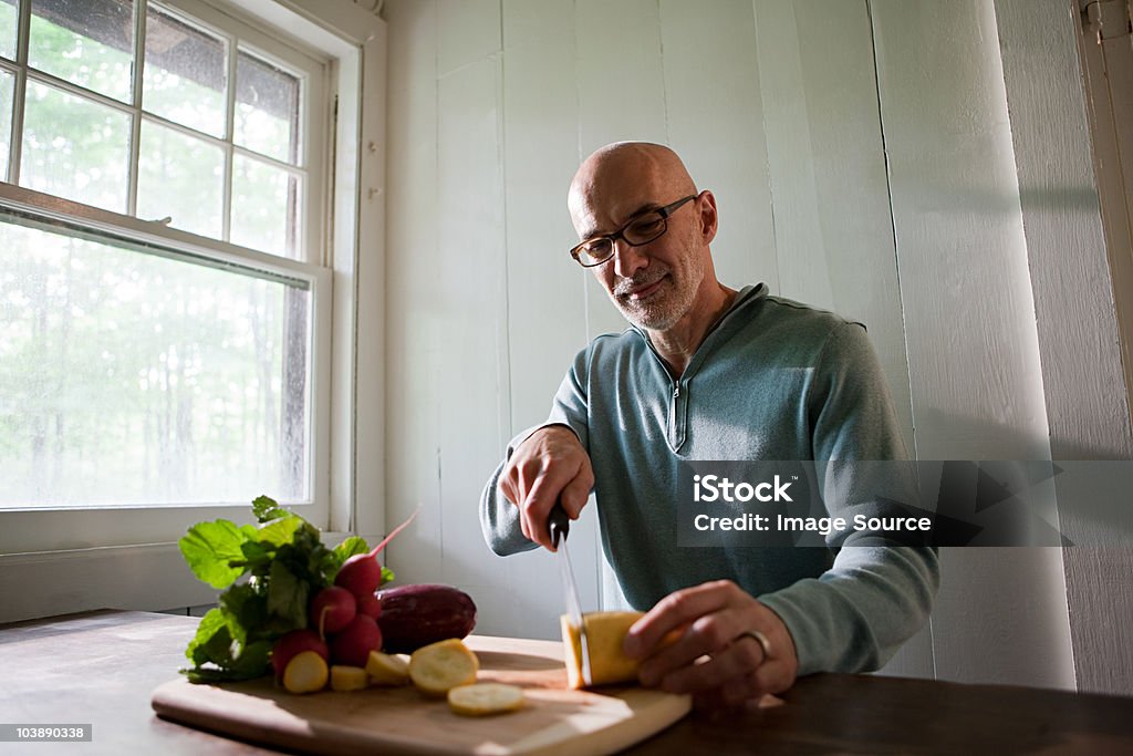 Senior man preparing food indoors  60-64 Years Stock Photo