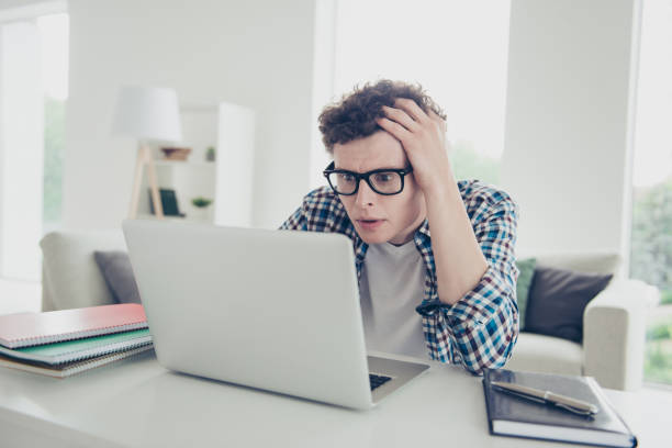 istock Handsome curly-haired serious young guy student, wearing casual, 1038910138