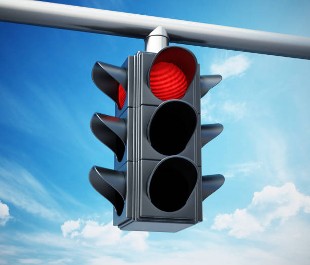 istock Red traffic light against blue sky 1038911534