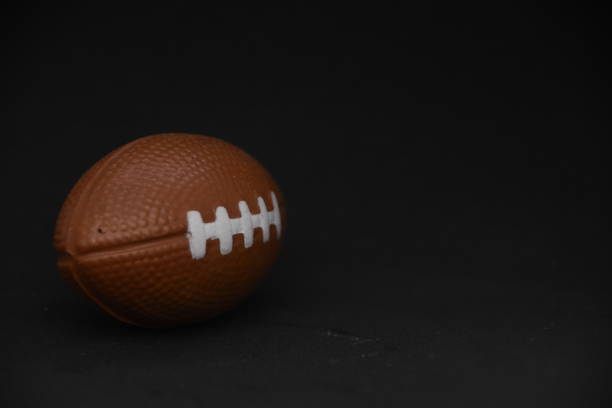 istock football on a black background 1038923580