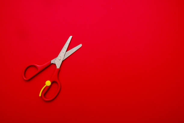 istock children's scissors on the red background with copy space 1038937392