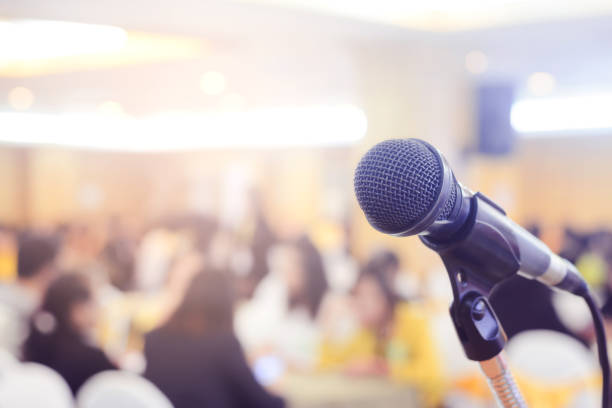 istock Microphone in conference on seminar room event background 1038938366