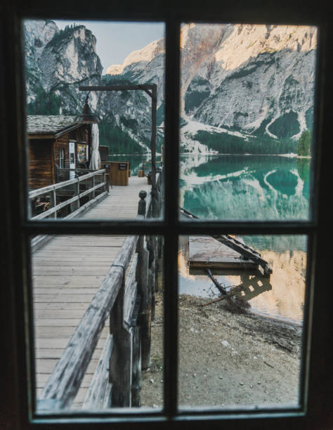 malerische aussicht auf den lago di braies durch das fenster in dolomiten - latemar mountain range stock-fotos und bilder