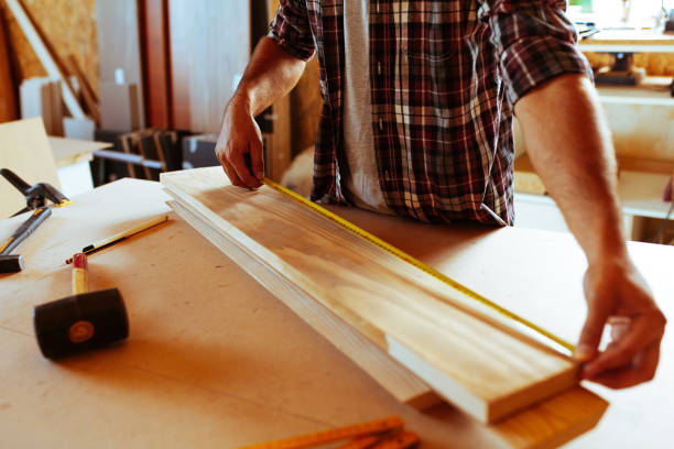 istock Carpenter doing his job in carpentry workshop. 1038947858