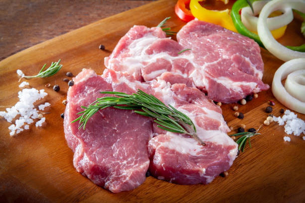 istock Fresh raw pork on wooden background. 1038959412