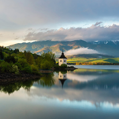 One small church on the lakeside just before sunset, when the light acquires a golden hue.   

- Liptovskà Mara, Slovakia