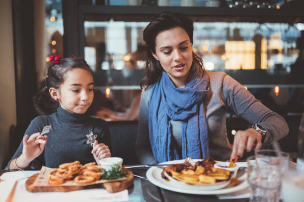 istock Family having dinner in restaurant 1038964050