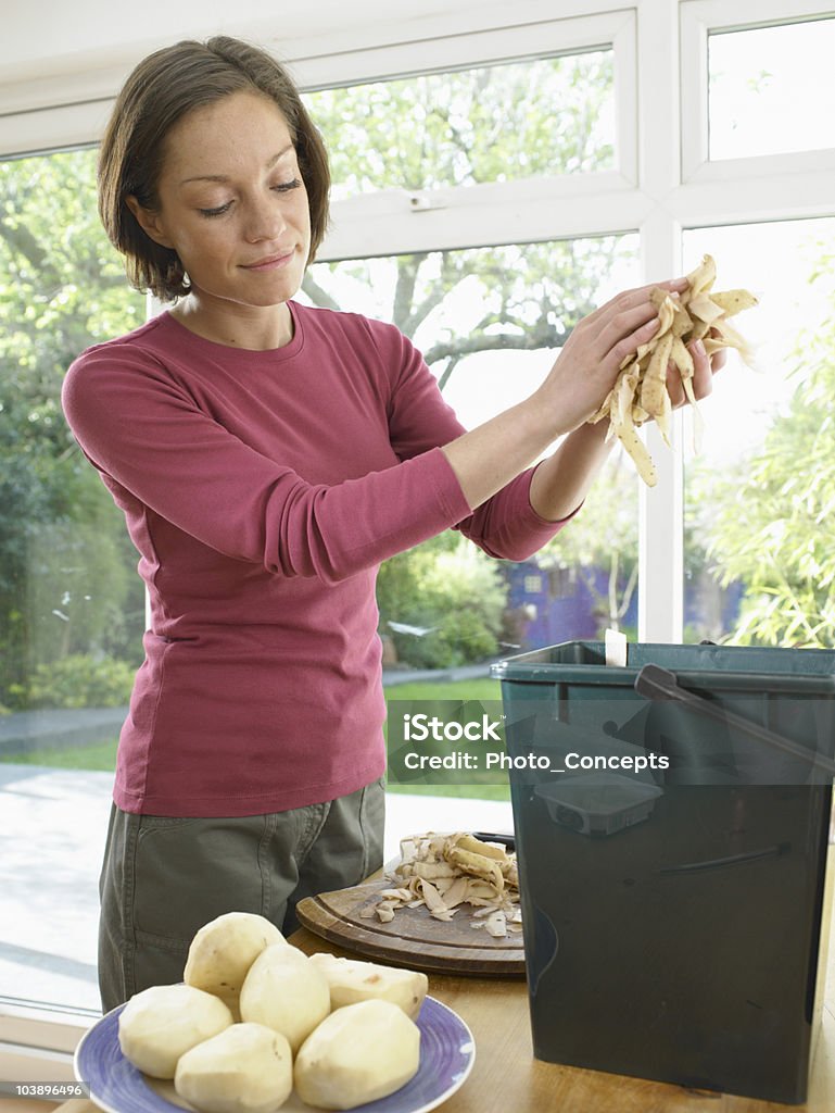 Woman recycling food waste  Raw Potato Stock Photo