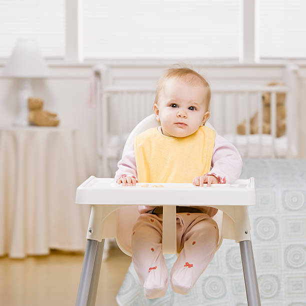 Portrait of baby in highchair  high chair stock pictures, royalty-free photos & images