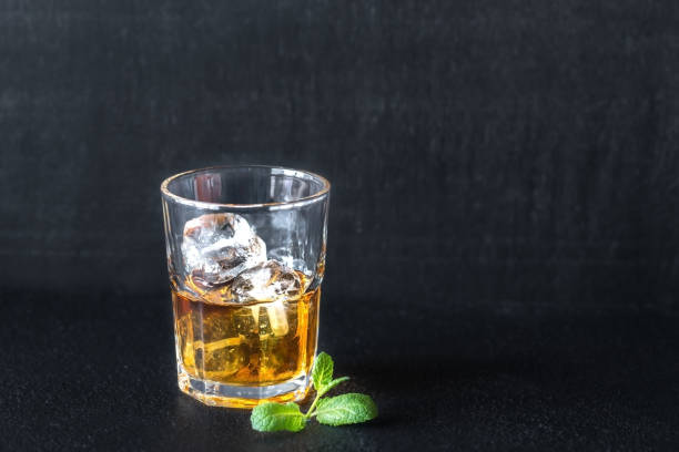 istock Glass of rum on the dark background 1038966334