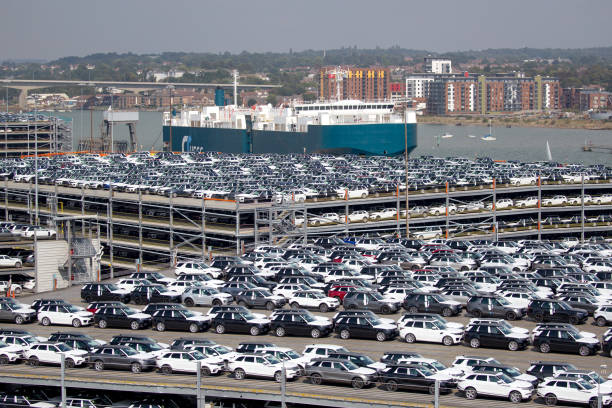 Rows of new British produced cars waiting at Southampton docks to be exported around the world via cargo ship. stock photo