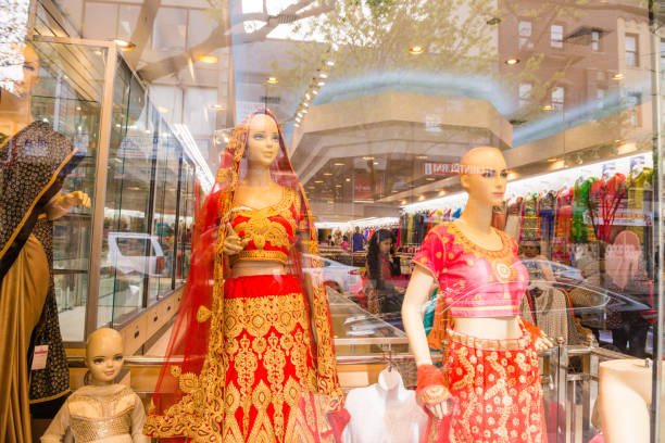 In New York City, United States in the Jackson Heights neighborhood of Queens Indian clothing for sale is displayed on mannequins in a retail storefront.