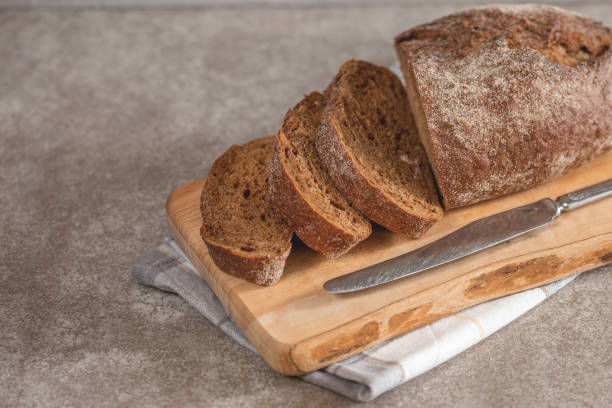 istock Fresh sliced rye bread on the wooden cutting board 1038985708