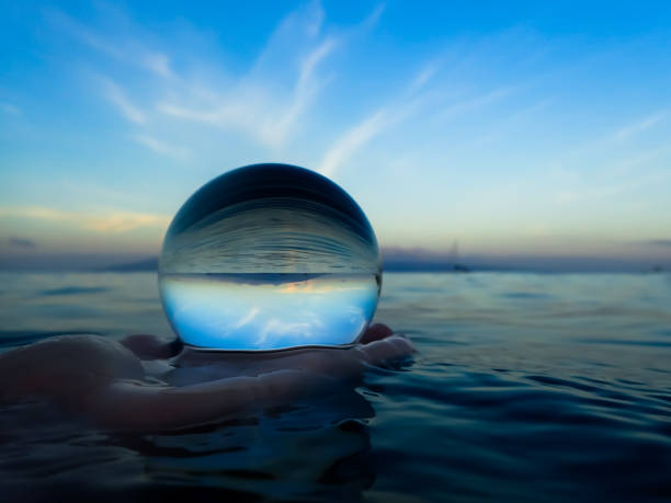 Ocean and Horizon with Clouds Caught in Glass Ball stock photo
