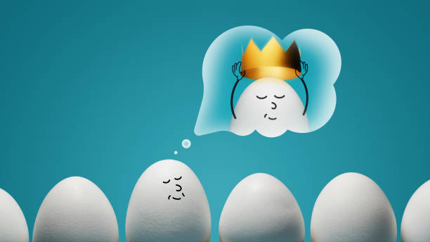 An egg is dreaming about golden crown on blue background. Concept of narcissism.