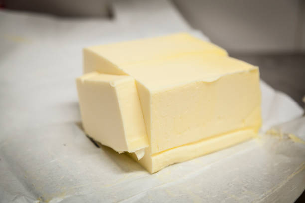 High quality butter block on paper with a sliced cut.