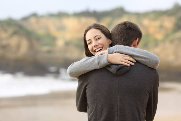 Couple of teens hugging on the beach