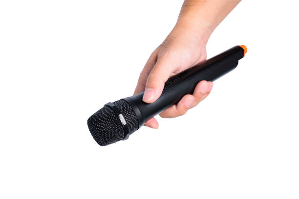 istock A man's hand is holding a black wireless microphone on white background or isolated 1039018158
