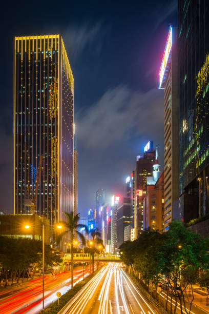istock Traffic zooming through neon night skyscraper cityscape Hong Kong China 1039023708