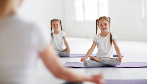 istock practicing engaged in gymnastics and yoga with  teacher 1039025016