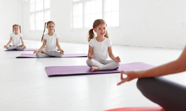 istock practicing engaged in gymnastics and yoga with  teacher 1039025530