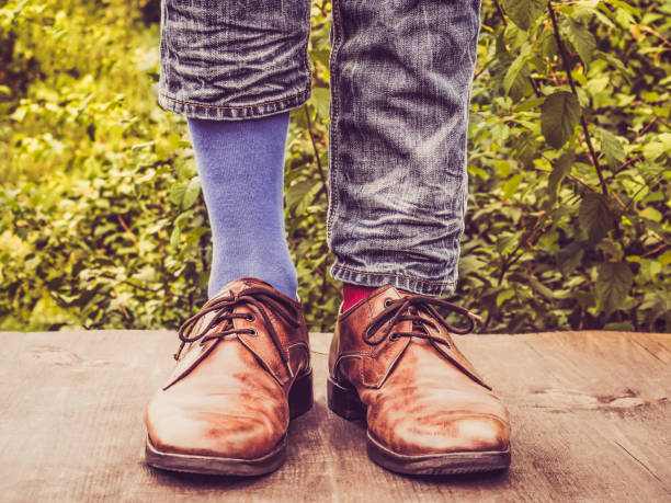 istock Men's legs in stylish shoes, bright, multi colored, variegated socks 1039044574