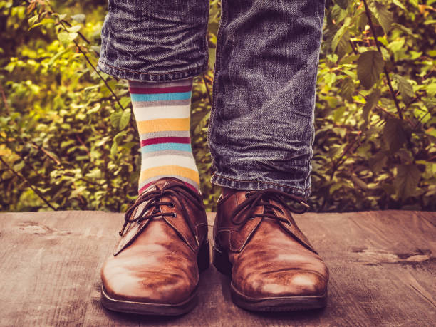 istock Men's legs in stylish shoes, bright, multi colored, variegated socks 1039045414