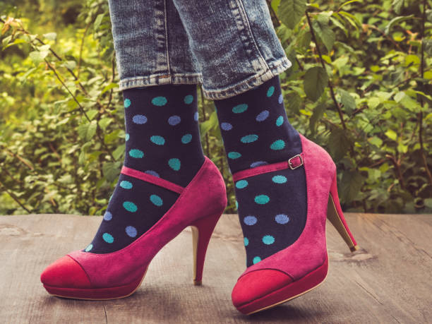 istock Women's legs in stylish shoes, bright, variegated, multi-colored socks 1039045652