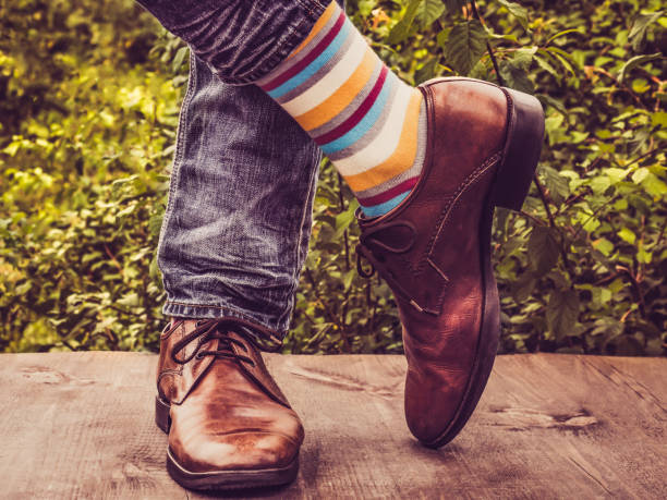 istock Men's legs in stylish shoes, bright, multi colored, variegated socks 1039045842