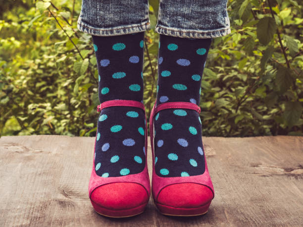 istock Women's legs in stylish shoes, bright, variegated, multi-colored socks 1039045846