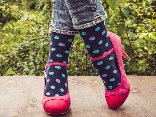 istock Women's legs in stylish shoes, bright, variegated, multi-colored socks 1039045862