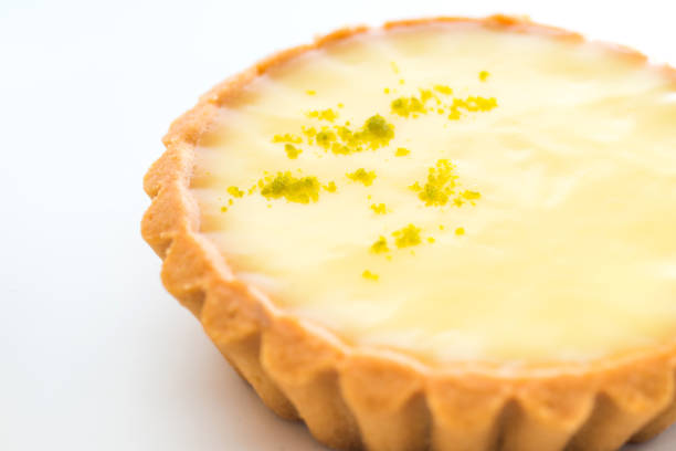One single lemon tart, isolated on white.