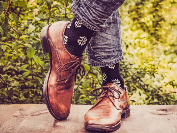 istock Men's legs in stylish shoes, black socks with patterns 1039049074