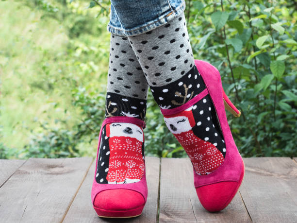istock Women's legs in stylish shoes, bright, variegated, multi-colored socks 1039049954
