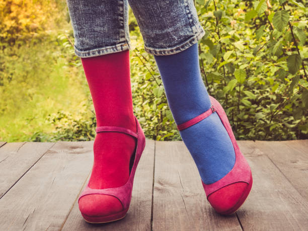 istock Women's legs in stylish shoes, bright, variegated, multi-colored socks 1039051652