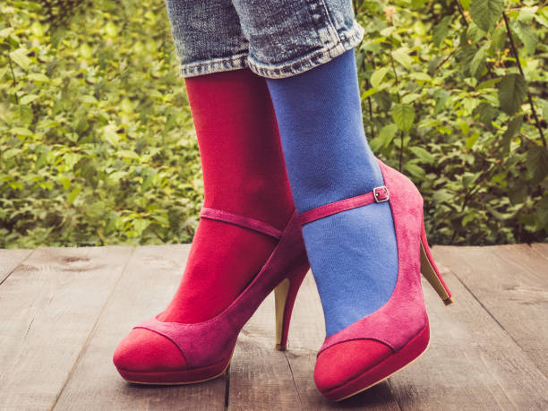istock Women's legs in stylish shoes, bright, variegated, multi-colored socks 1039054456