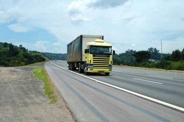 no brand yellow semi truck on four lane highway