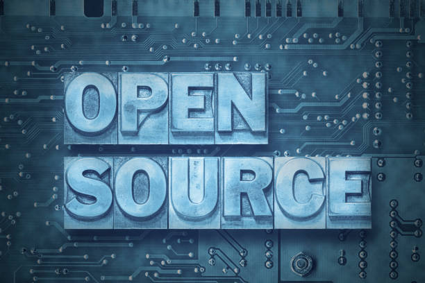 open source - pc board open source phrase made from metallic letterpress blocks on the pc board background origins stock pictures, royalty-free photos & images
