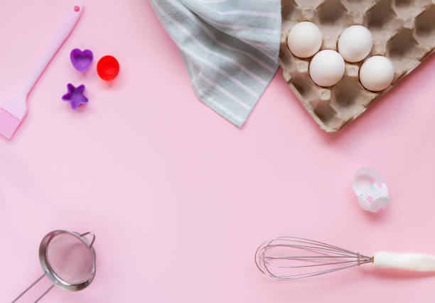 istock Dessert ingredients and utensils on pink pastel background 1039079902
