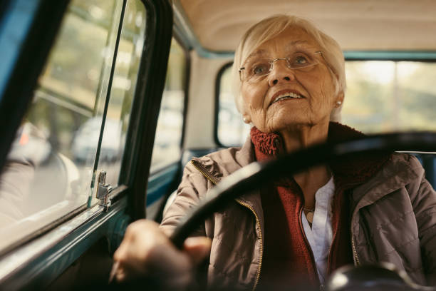 istock Senior female driving a vintage car 1039084344