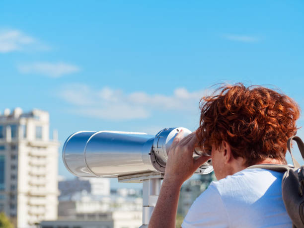 istock Woman sightseeing through observation binocular 1039085710