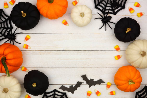 istock Black, orange and white Halloween frame over white wood 1039098710