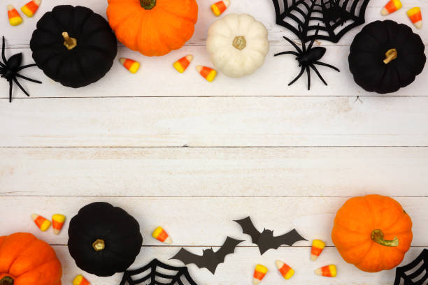 istock Black, orange and white Halloween double border over white wood 1039099022