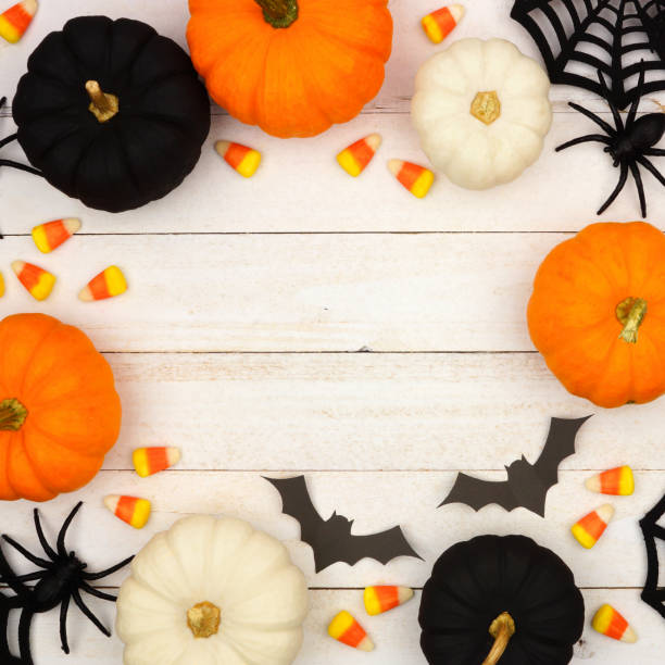 istock Black, orange and white Halloween frame over white wood 1039099456